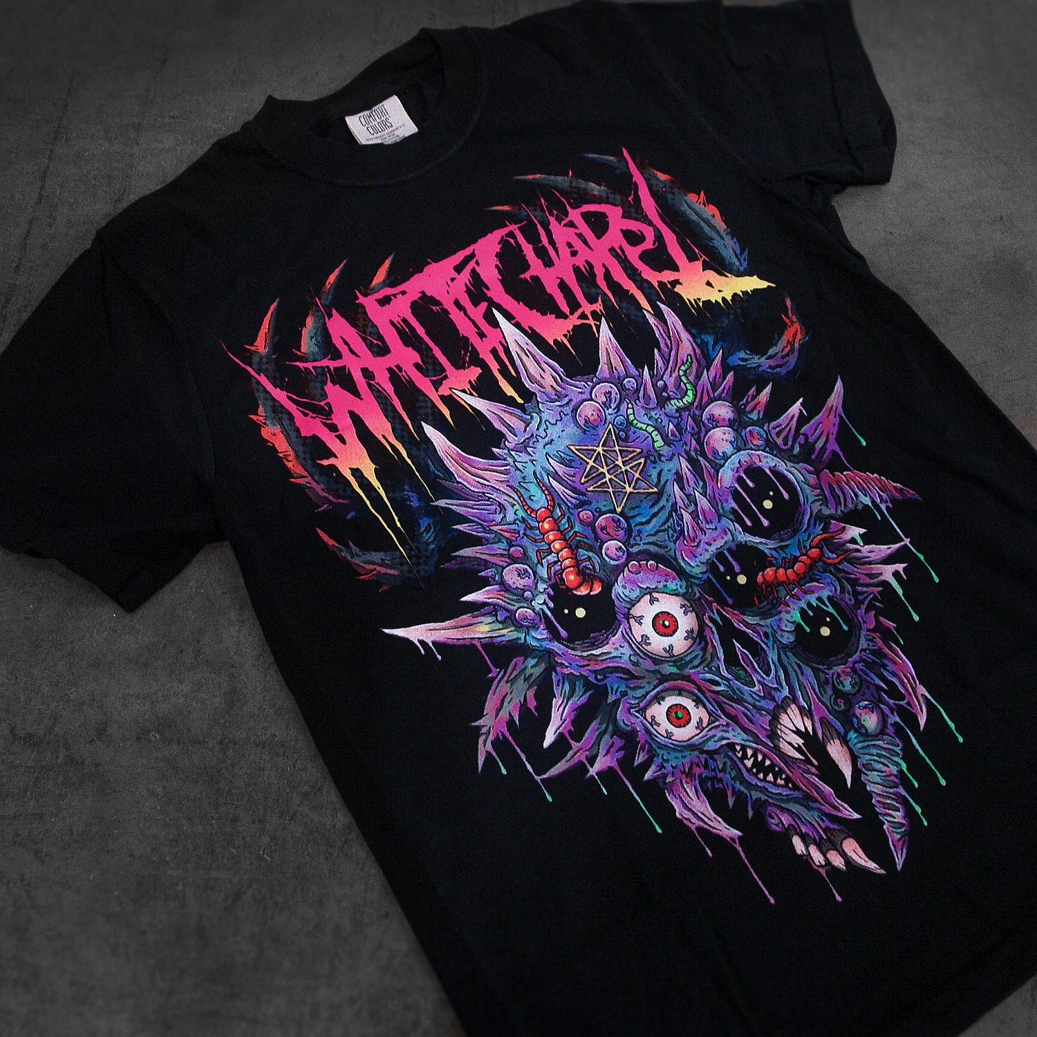 A black Whitechapel t-shirt with a vibrant, spiky demonic skull graphic—multiple eyes and sharp teeth—plus 